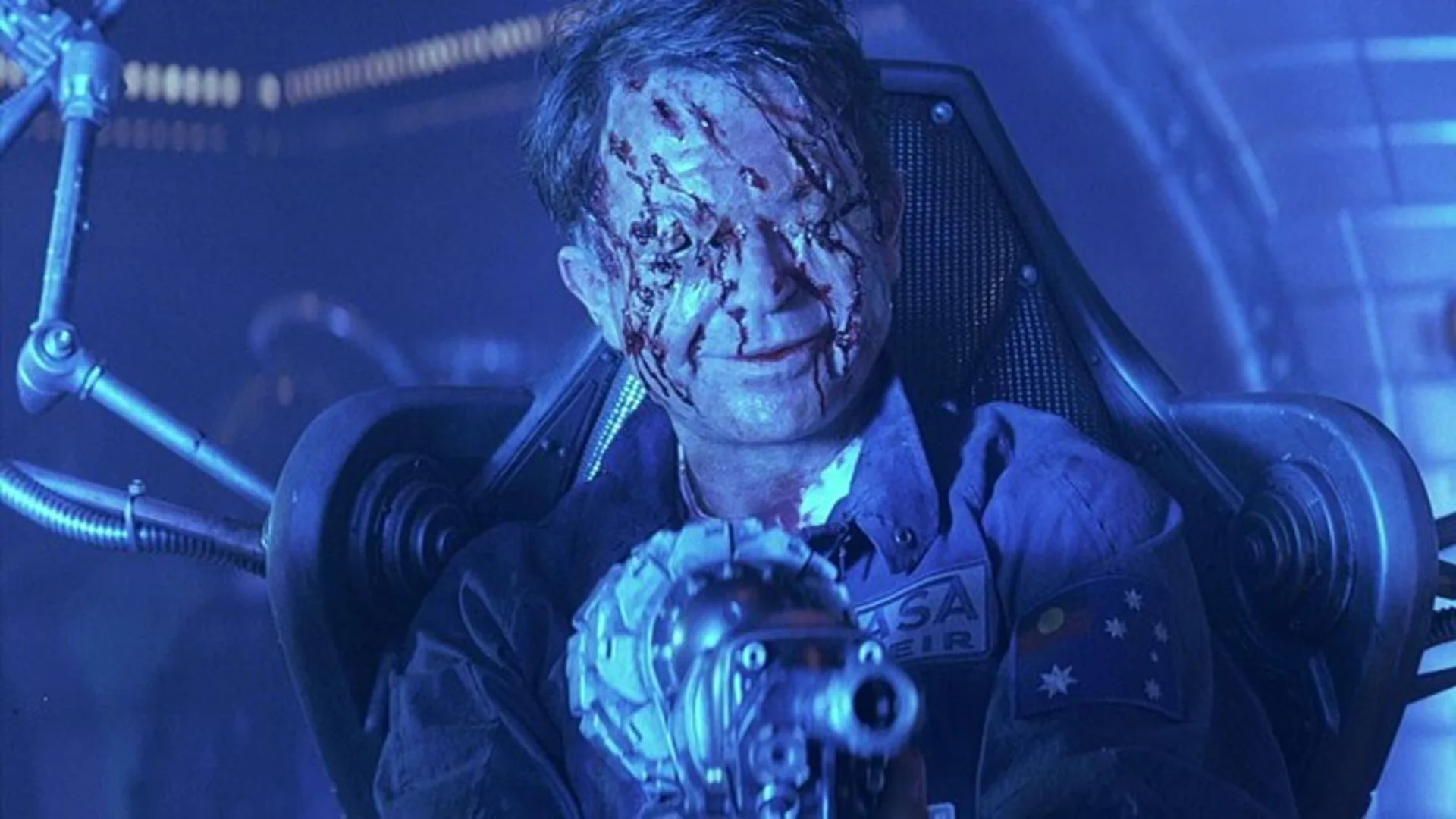 Sam Neill from the sci-fi horror movie 'Event Horizon' shown possessed with his eyes removed and blood on face.